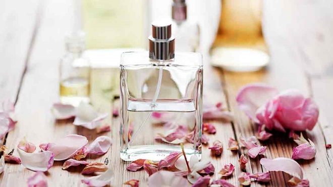 perfume bottle surrounded by rose petals